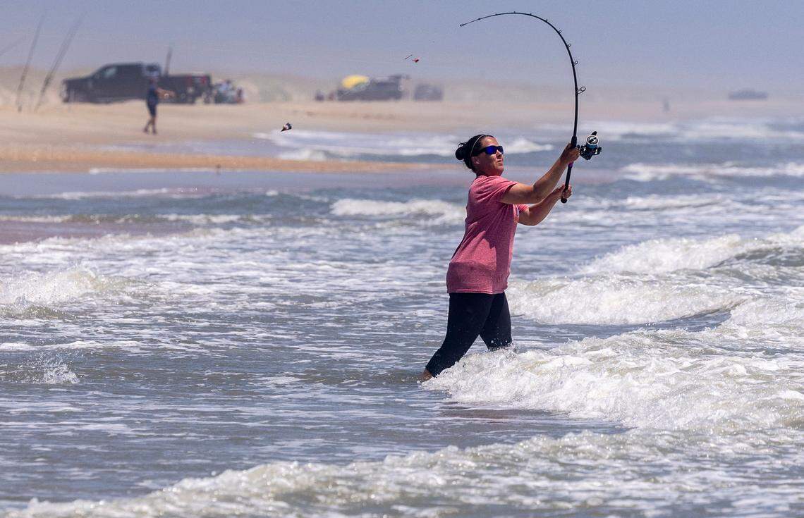 A woman casts while surf fishing on the Outer Banks.