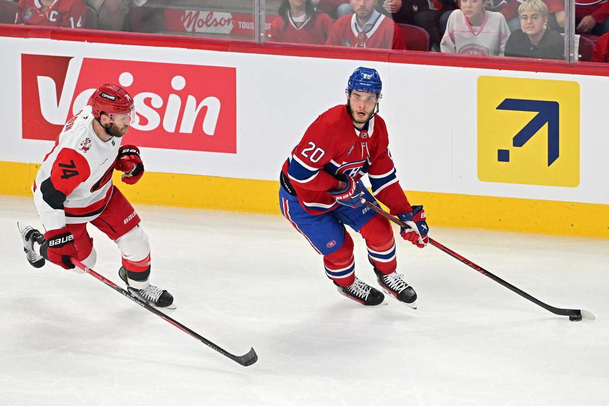 Juraj Slafkovsky (20) of the Montreal Canadiens skates with the puck against Jaccob Slavin of the Carolina Hurricanes during the first period in Game 4 of the Eastern Conference Final of the 2026 Stanley Cup Playoffs at Bell Centre on May 27, 2026 in Montreal, Quebec, Canada.