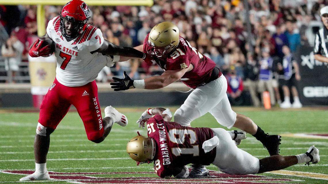 North Carolina State running back Zonovan Knight (7) tries to break free Boston College defensive lineman Jake Byczko (91) and linebacker Isaiah Graham-Mobley (19) during the first half of an NCAA college football game, Saturday, Oct. 16, 2021, in Boston.