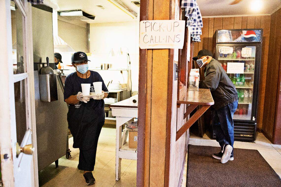 Gerri Grady takes a lunch order out to a customer at GradyÕs Barbecue on Friday, Oct. 30, 2020. Gerri and her husband, Steve Grady, have run GradyÕs Barbecue since 1986 in Dudley, NC.