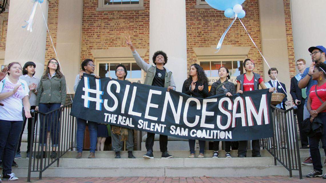 Members of The Real Silent Sam Coalition placed a black garment on the barrel of the statue’s gun Monday, Oct. 12, 2015. The skirt symbolized the skirt that industrialist Julian Carr said at the statue’s 1913 dedication hung in shreds after he “horsewhipped a Negro wench” for insulting a Southern lady on the street.  Between 30 and 40 members of the coalition marched from McCorkle Place to Memorial Hall where they briefly disrupted the University Day proceedings to decry the memorial to Confederate soldiers of the university and racism they say persists on campus.  