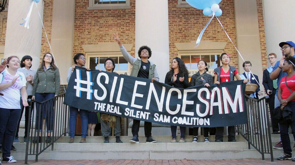 Members of The Real Silent Sam Coalition placed a black garment on the barrel of the statue’s gun Monday, Oct. 12, 2015. The skirt symbolized the skirt that industrialist Julian Carr said at the statue’s 1913 dedication hung in shreds after he “horsewhipped a Negro wench” for insulting a Southern lady on the street.  Between 30 and 40 members of the coalition marched from McCorkle Place to Memorial Hall where they briefly disrupted the University Day proceedings to decry the memorial to Confederate soldiers of the university and racism they say persists on campus.  