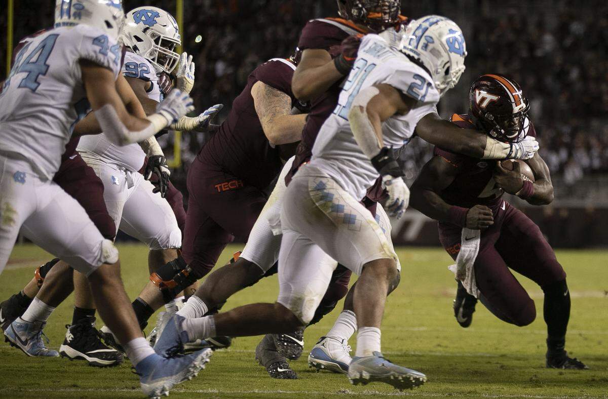 Virginia Tech quarterback Quincy Patterson II (4) scores in the sixth overtime period to give Virginia Tech a 43-41 victory over North Carolina on Saturday, October 19, 2019 at Lane Stadium in Blacksburg, Va.