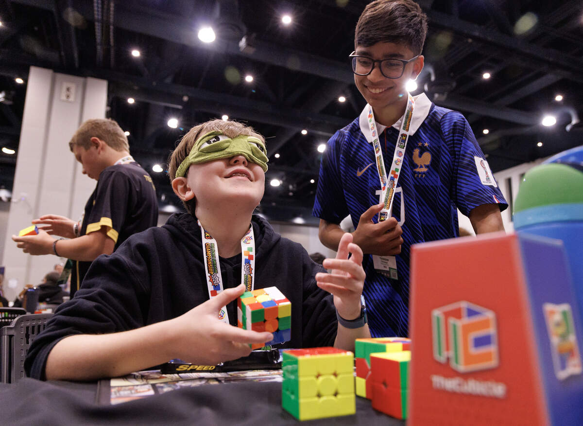 Oliver Kayse, 13, and Yaseen Farooqui, 13, practice solving a cube puzzle blindfolded during the Rubik’s WCA North American Championship at the Raleigh Convention Center on Thursday, July 2, 2026.