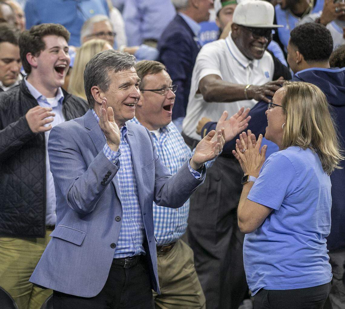 North Carolina Governor Roy Cooper and House Speaker Tim Moore relish in North Carolina’s 81-77 victory over Duke in the NCAA Final Four semi-final on Saturday, April 2, 2022 at Caesars Superdome in New Orleans, La.