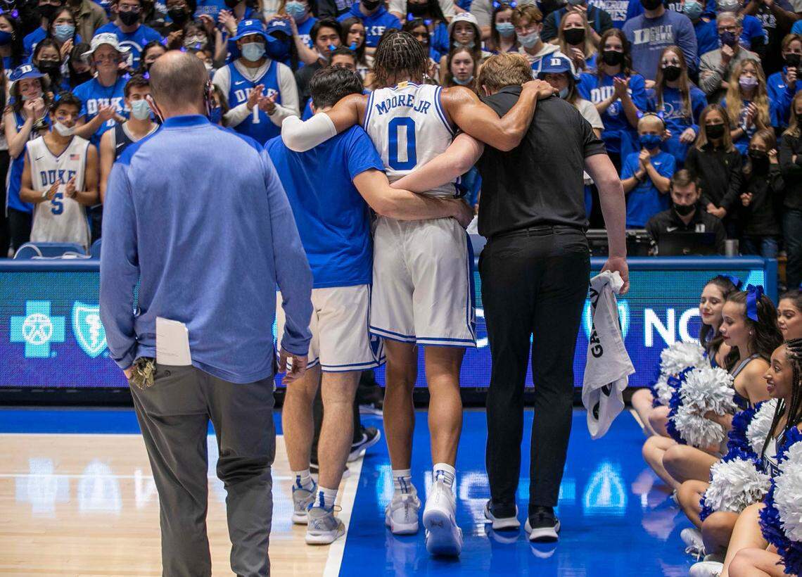 Duke’s Wendell Moore Jr. (0) is escorted off the court after an injury at the start of the Blue Devil’s game against Campbell on Saturday, November 13, 2021 at Cameron Indoor Stadium in Durham, N.C. Moore returned to play later and scored 15 points.
