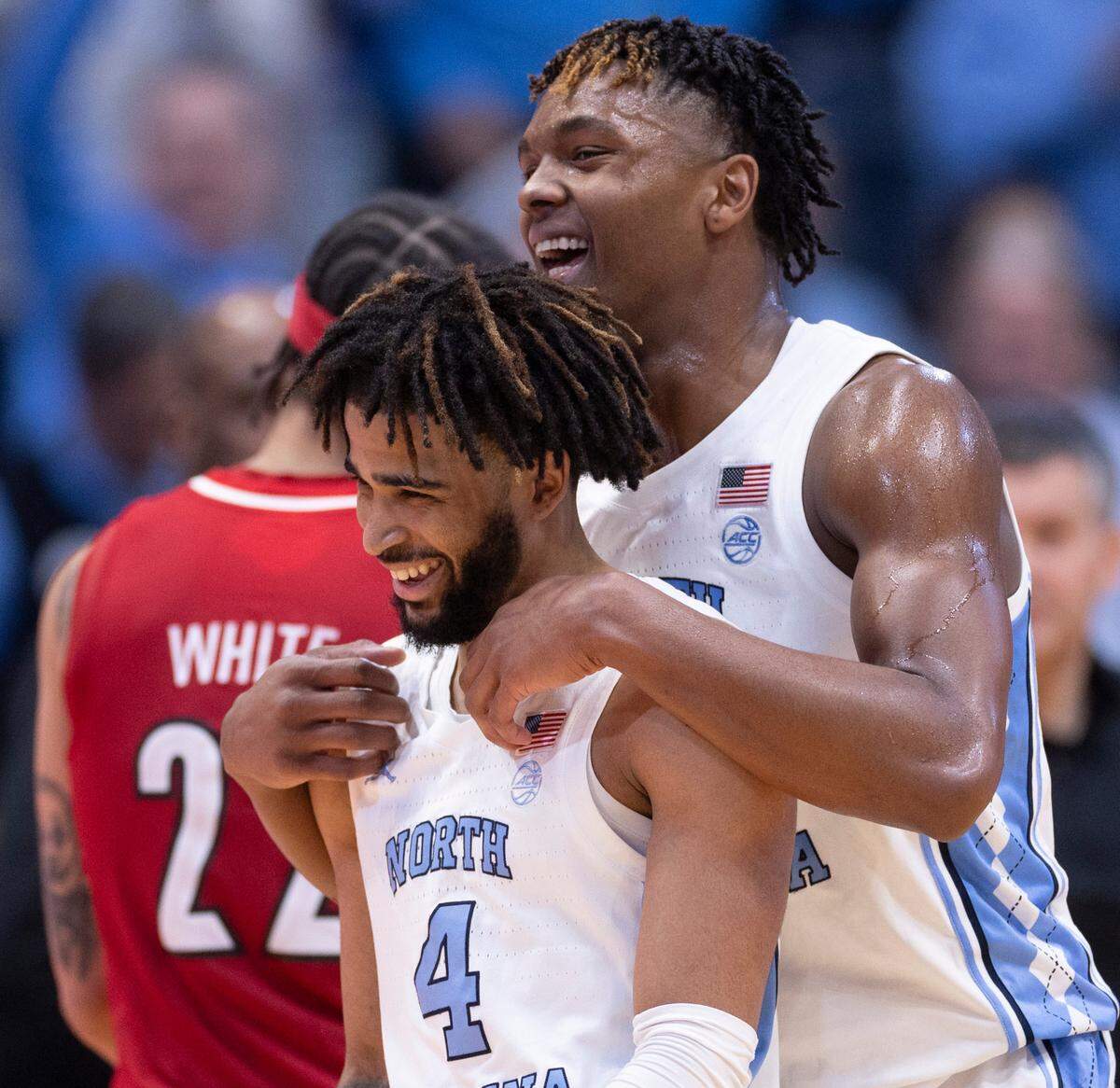 North Carolina’s Harrison Ingram (55) embraces R.J. Davis (4) after Davis’ basket gave the Tar Heels’ a 79-63 lead in the second half against Louisville. Davis led all scores with 21 points in North Carolina’s 86-70 victory