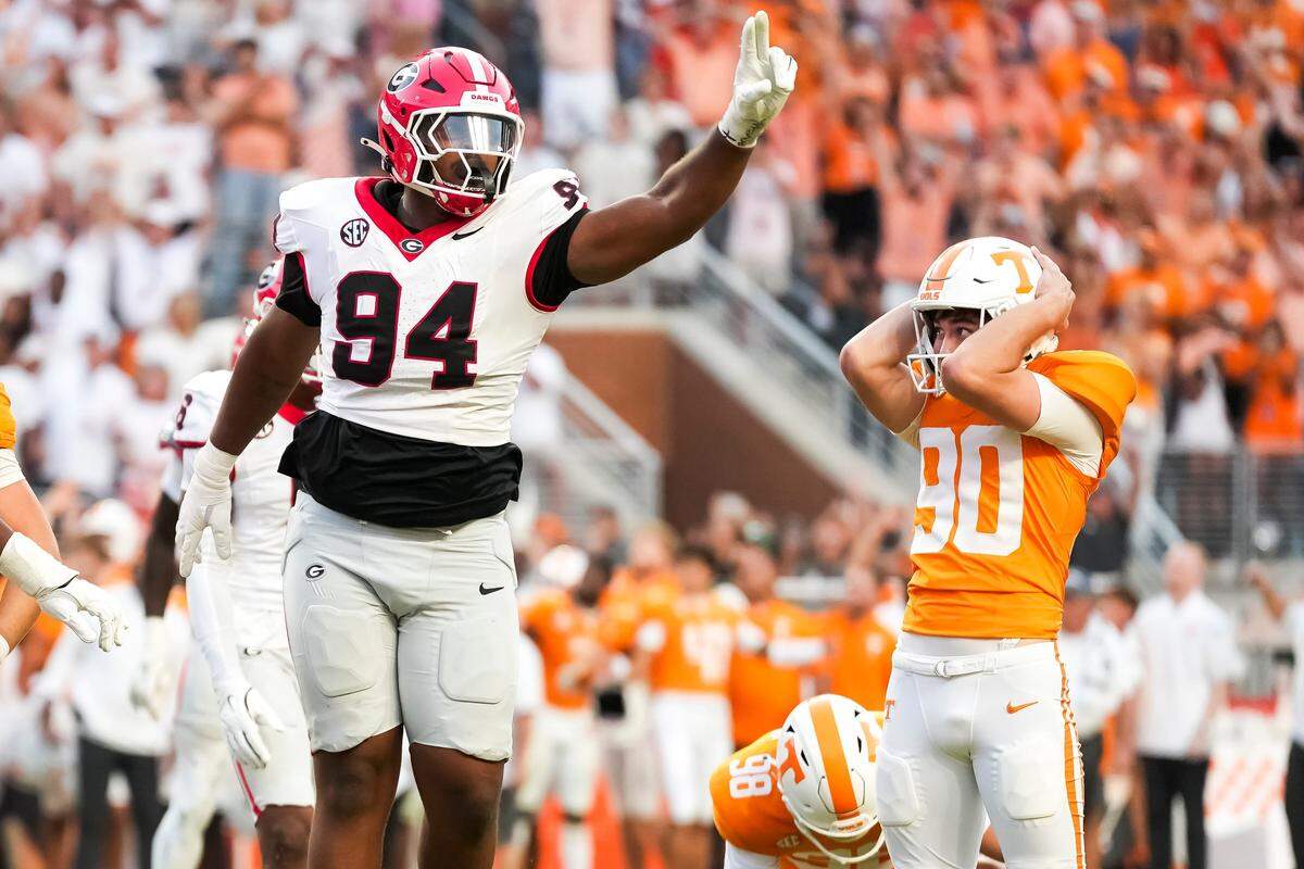 Tennessee place kicker Max Gilbert (90) holds his helmet in disbelief as Georgia defensive lineman Xzavier McLeod (94) celebrates Gilbert's missed field goal in the final seconds of a college football game between Tennessee and Georgia at Neyland Stadium in Knoxville, Tenn., on Sept. 13, 2025.