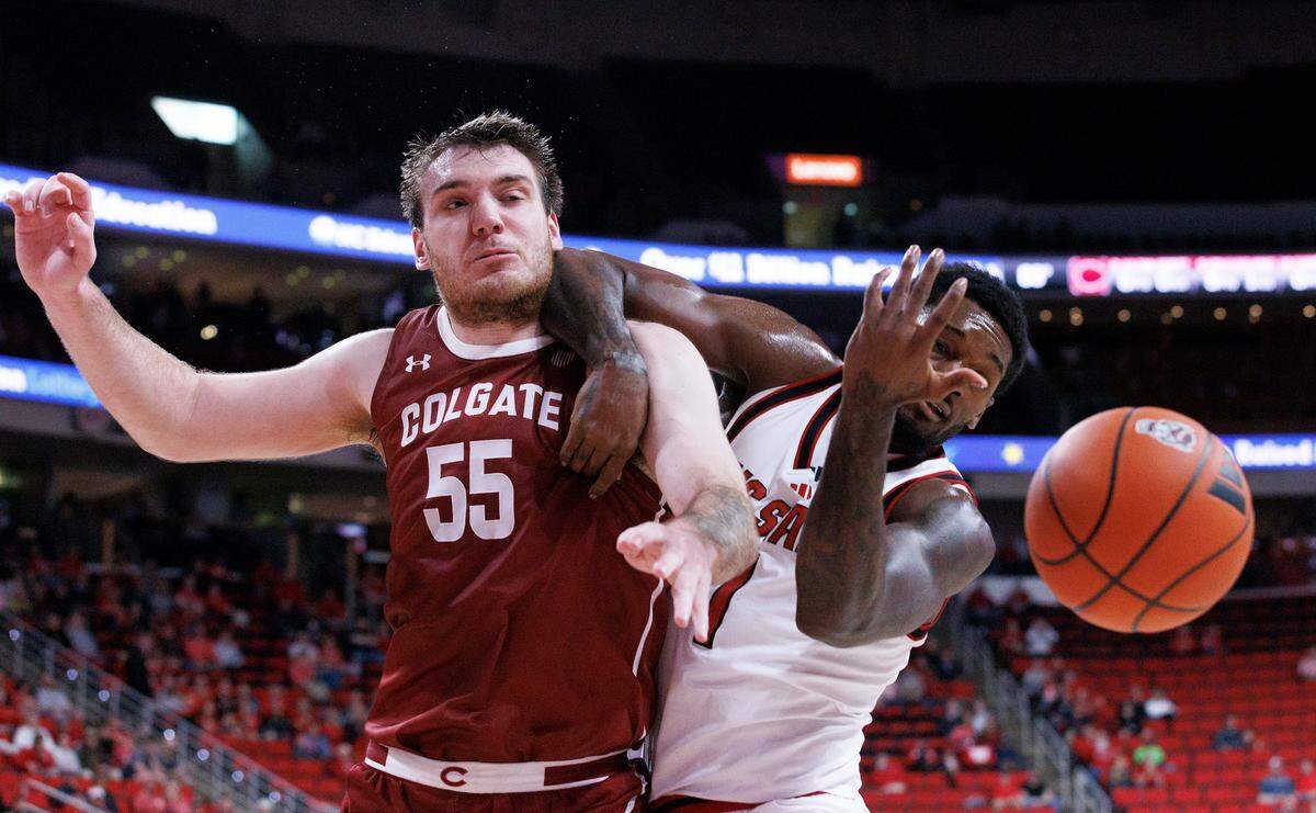 Colgate’s Jeff Woodward and N.C. State’s Brandon Huntley-Hatfield battle for a rebound during the first half of the Wolfpack’s game at Lenovo Center on Monday, Nov. 18, 2024, in Raleigh, N.C.