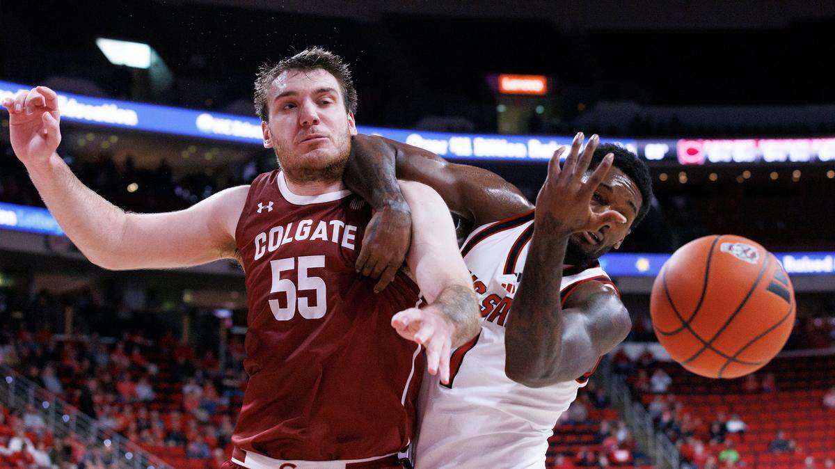 Colgate’s Jeff Woodward and N.C. State’s Brandon Huntley-Hatfield battle for a rebound during the first half of the Wolfpack’s game at Lenovo Center on Monday, Nov. 18, 2024, in Raleigh, N.C.