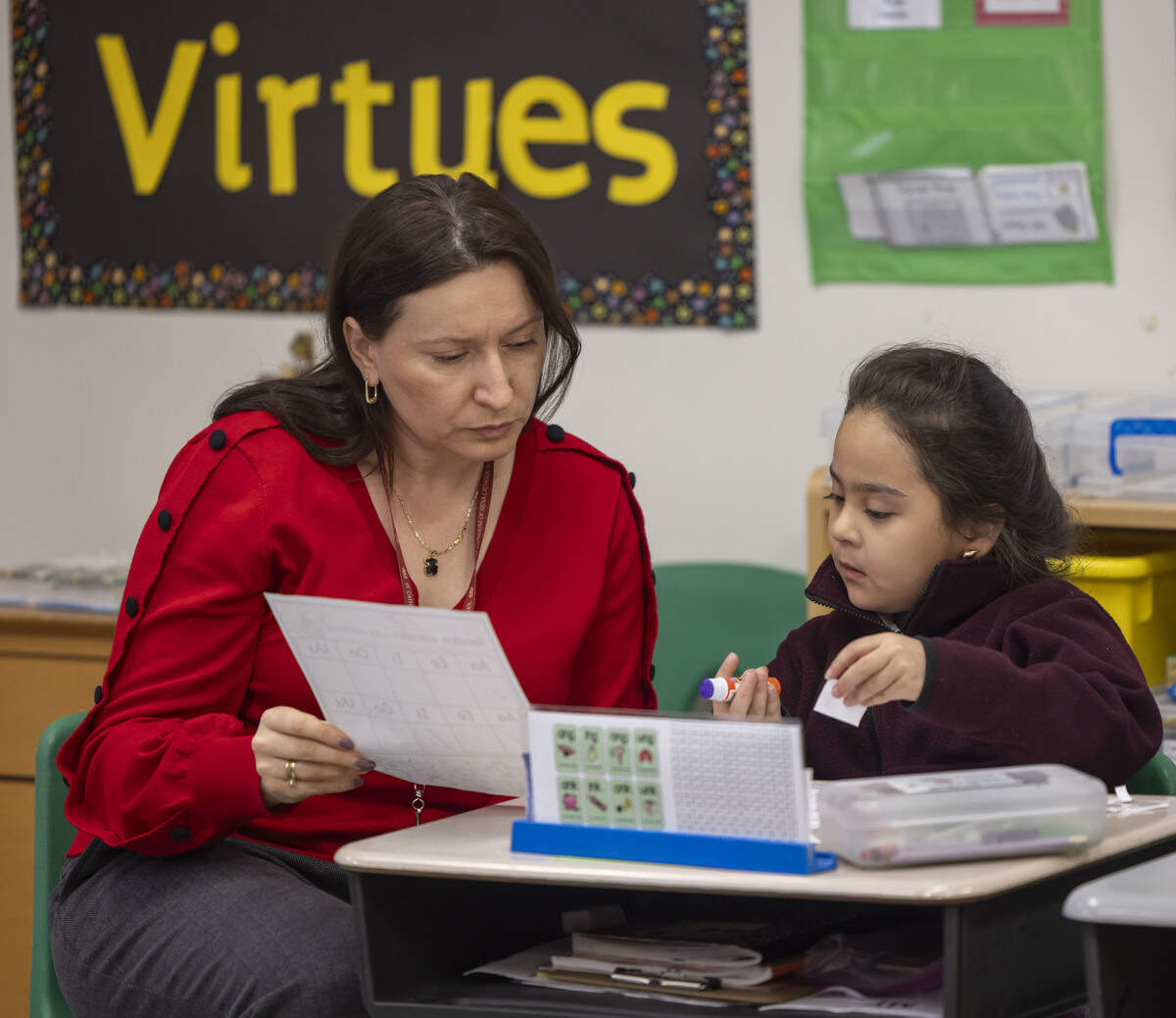 Spanish teacher Monica Pietron, works with Ana Chavero at St. Catherine of Siena Catholic School on Feb. 12, 2026 in Wake Forest, N.C. State data indicates nearly 75% of private school students are getting an Opportunity Scholarship from the state.
