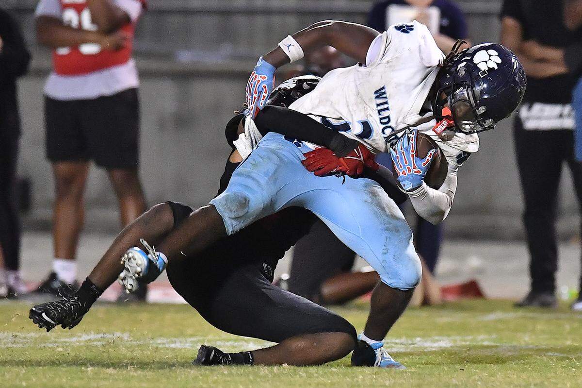 Millbrook running back Brilison McCullers (3) gets the first down after the tackle from Rolesville's Avery Fleet (7) during the first half. The Millbrook Wildcats and the Rolesville Rams met in a conference football game in Rolesville, N.C. September 26, 2025