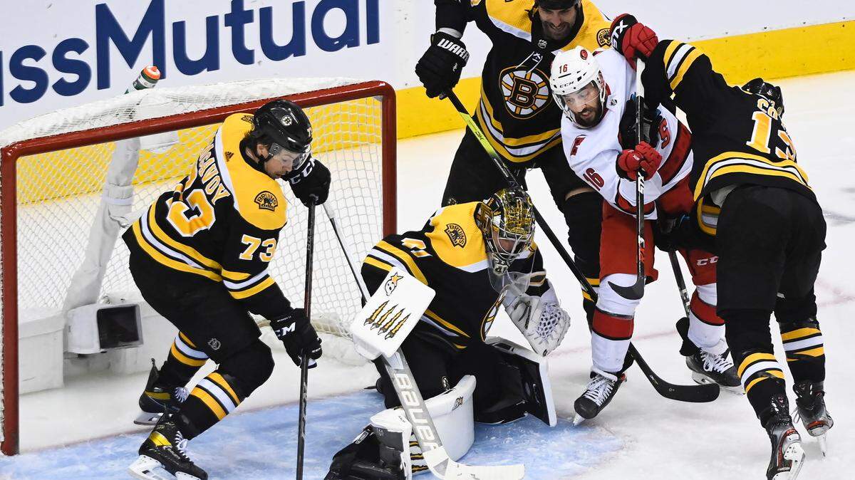 Carolina Hurricanes center Vincent Trocheck (16) tries to get the loose puck on a save by Boston Bruins goaltender Jaroslav Halak (41) as Bruins teammates Charlie McAvoy (73) Zdeno Chara (33) and Charlie Coyle (13) keep close during the second period of an NHL Eastern Conference Stanley Cup playoff hockey game in Toronto, Ontario, on Wednesday, Aug. 19, 2020. (Nathan Denette/The Canadian Press via AP)