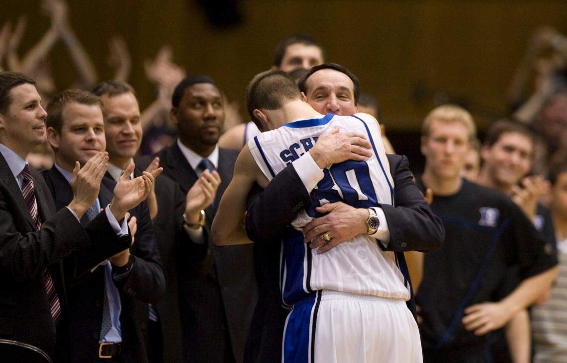 Duke senior Jon Scheyer gets a hug from coach Mike Krzyzewski after scoring 20 points in Duke’s 82-50 win. PHOTOS BY CHUCK LIDDY - cliddy@newsobserver.com