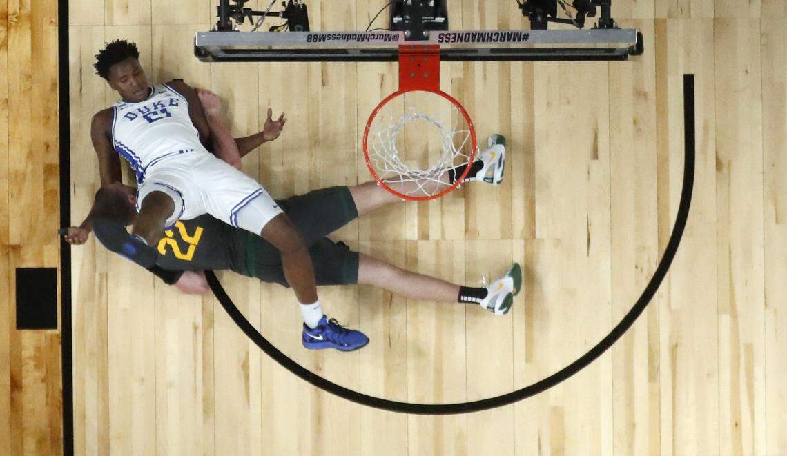 Duke’s Patrick Ngongba II (21) is tangled up with Baylor’s Marino Dubravcic (22) during Duke’s 89-66 victory over Baylor in the second round of the 2025 NCAA men’s basketball championship at the Lenovo Center in Raleigh, N.C., Sunday, March 23, 2025. Dubravic was called for a technical on the play.