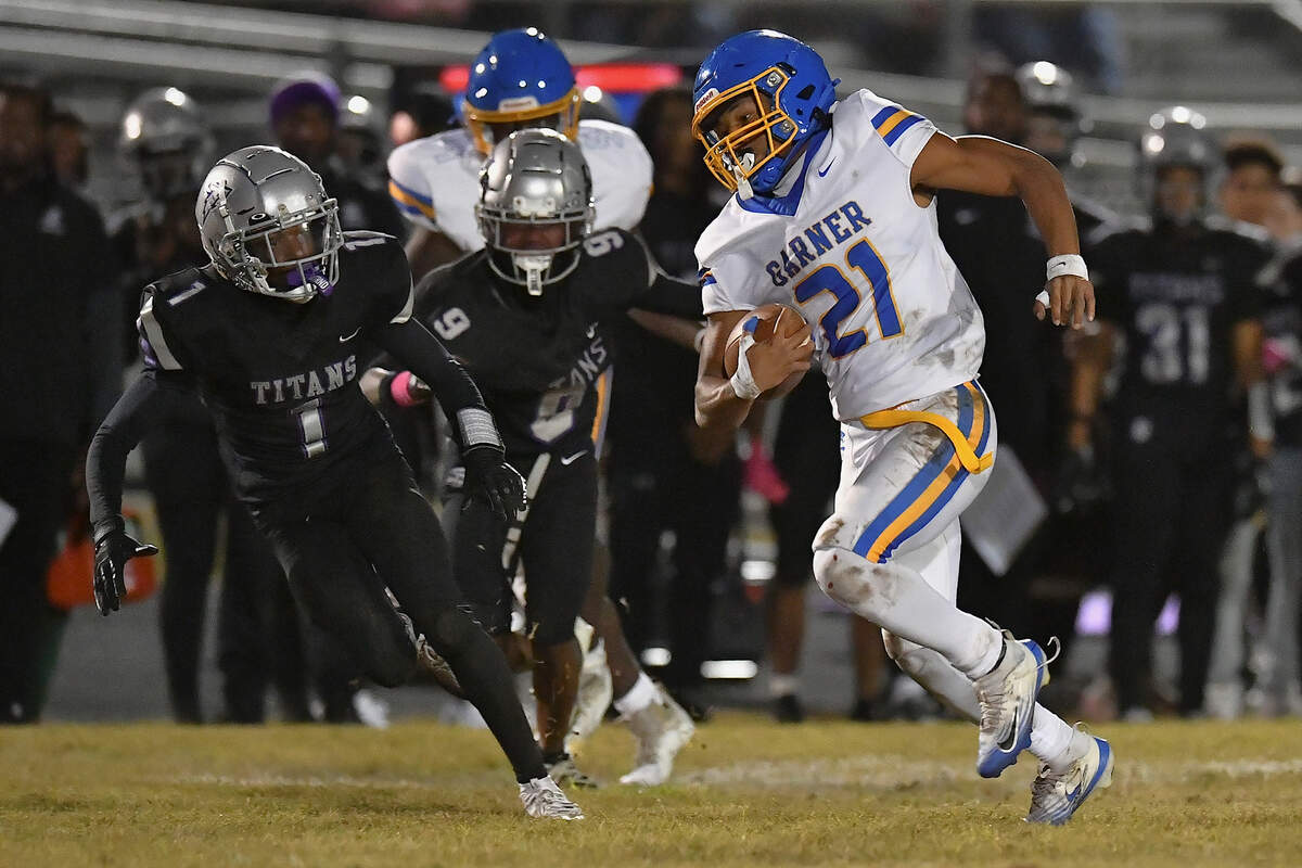 Garner running back Tayden McPhatter (21) runs for the touchdown against South Garner's Caleb Sykes (1) during the first half. The South Garner Titans and the Garner Trojans met in a conference football game in Raleigh, N.C. October 17, 2025