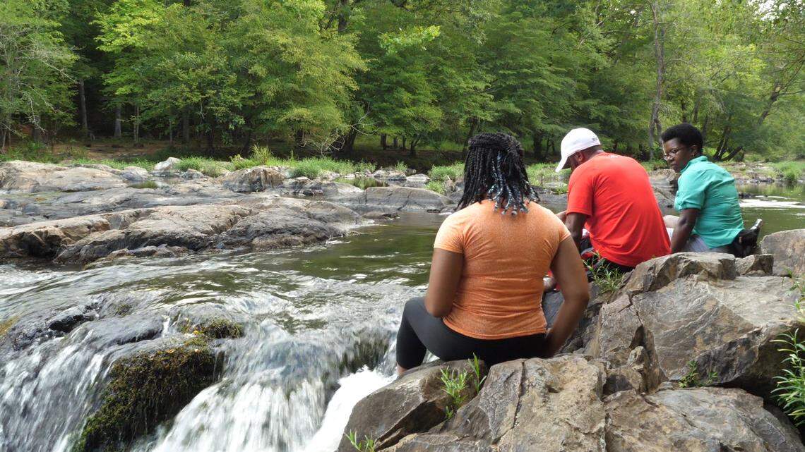 Hikers from the Eno River Outdoor Afro hike take a moment to cool off.