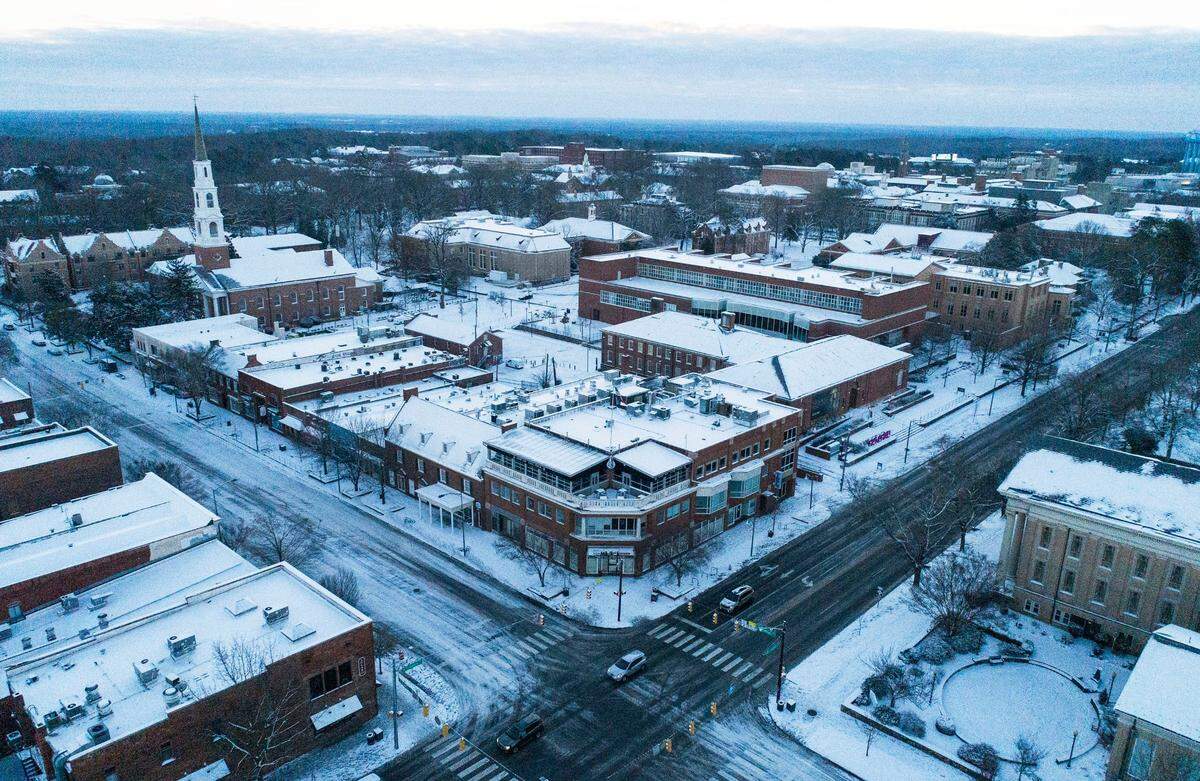 Snow is seen covering buildings and roads in downtown Chapel Hill, N.C. on Saturday morning, Jan. 22, 2022.