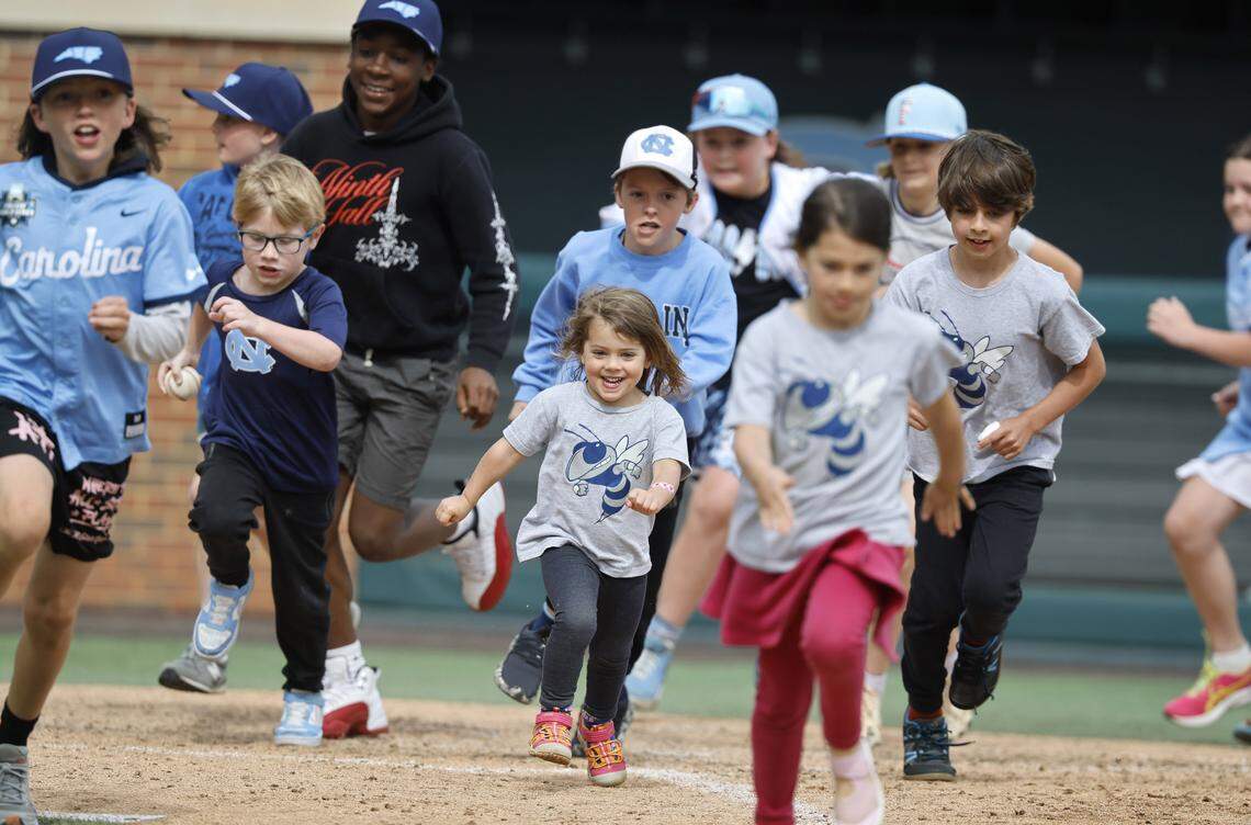 Kids run the bases after North Carolina's game against Georgia Tech at Boshamer Stadium in Chapel Hill, N.C., Sunday, April 19, 2026.