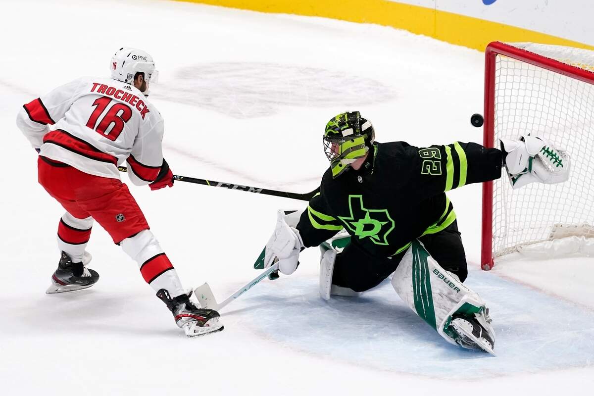 Carolina Hurricanes center Vincent Trocheck (16) scores against Dallas Stars’ Jake Oettinger (29) during the shootout in an NHL hockey game in Dallas, Saturday, Feb. 13, 2021. The Hurricanes won 4-3. (AP Photo/Tony Gutierrez)