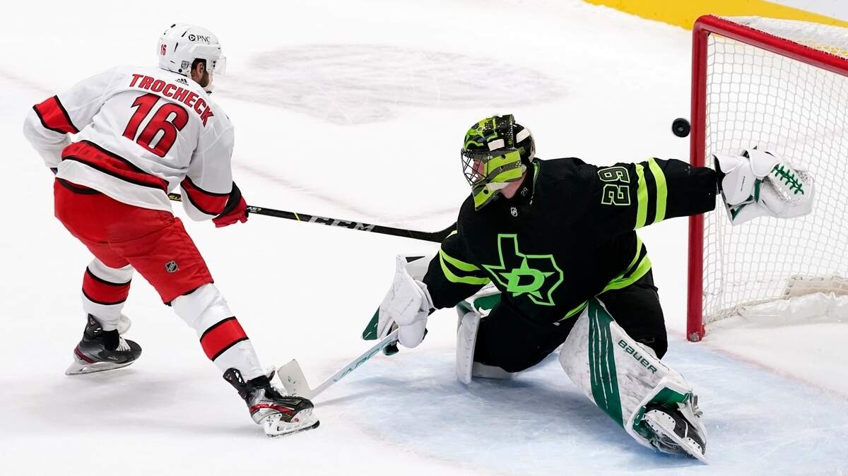 Carolina Hurricanes center Vincent Trocheck (16) scores against Dallas Stars’ Jake Oettinger (29) during the shootout in an NHL hockey game in Dallas, Saturday, Feb. 13, 2021. The Hurricanes won 4-3. (AP Photo/Tony Gutierrez)
