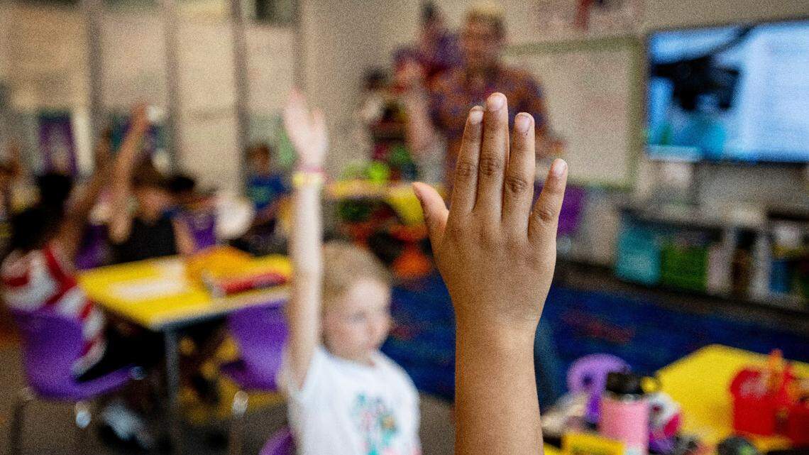 Third graders raise their hands to answer questions during a lesson on fractions in Tyler Ellzey’s class at Buckhorn Creek Elementary in Holly Springs, N.C.
