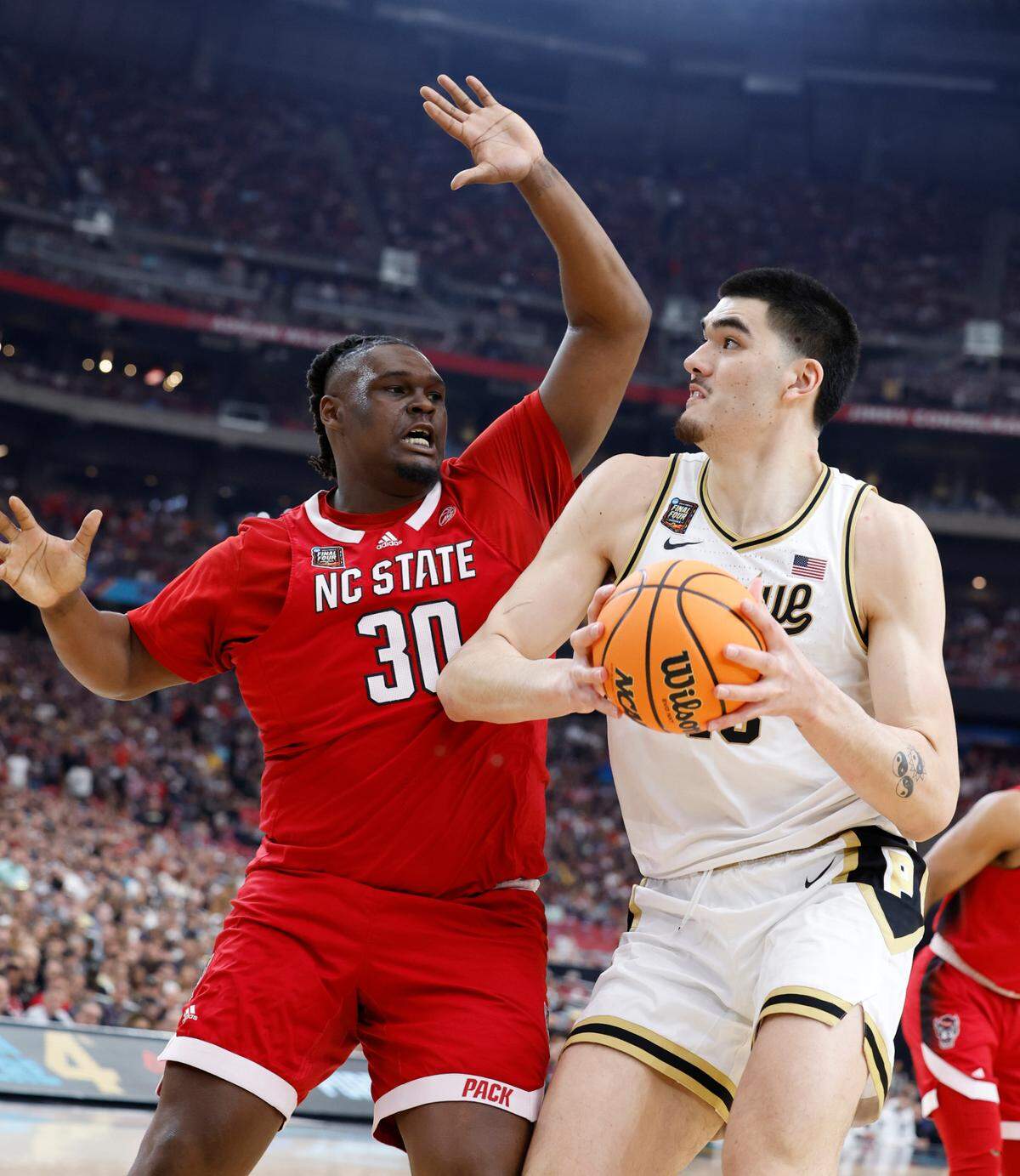 NC State’s DJ Burns defends against Purdue center Zack Edey early in the first half of their NCAA Final Four game, Saturday evening, April 6, 2024.