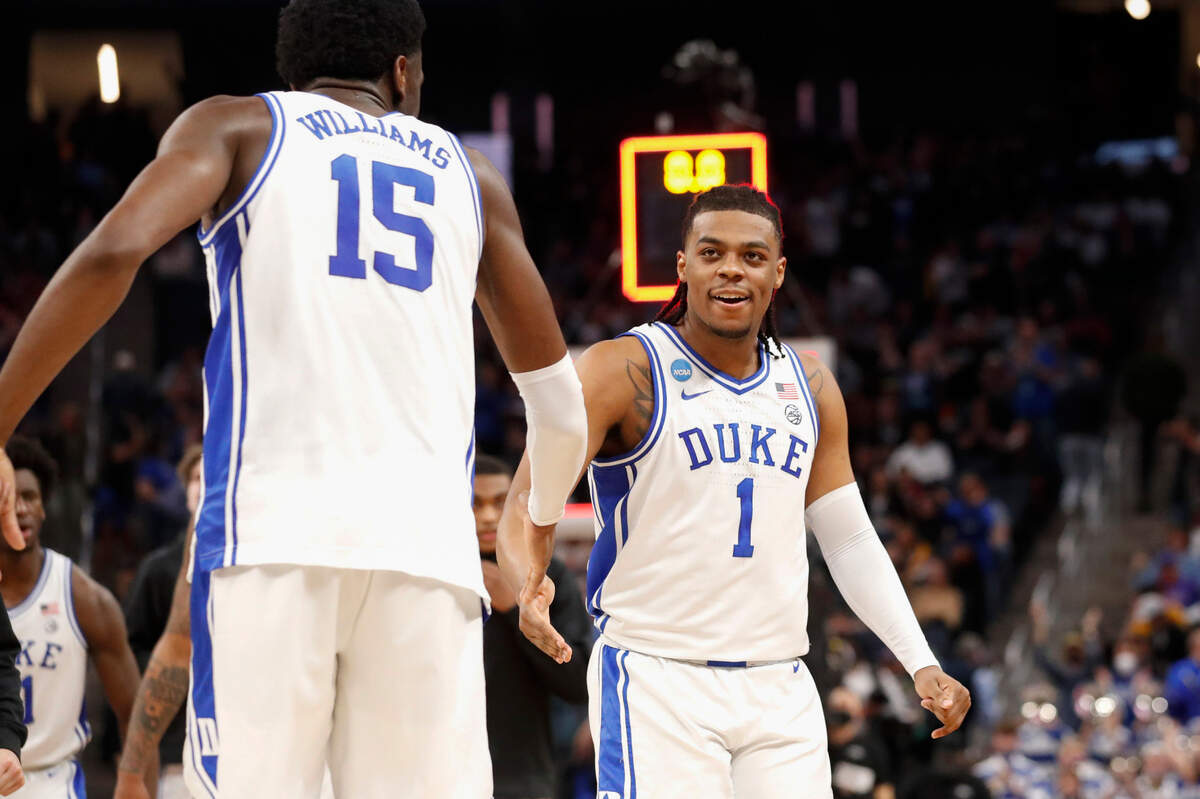Dukeís Mark Williams (15) congratulates Trevor Keels (1) after he made a three-pointer during the first half of Dukeís game against Arkansas in the NCAA Tournament West Regional finals at the Chase Center in San Francisco, Calif., Saturday, March 26, 2022.
