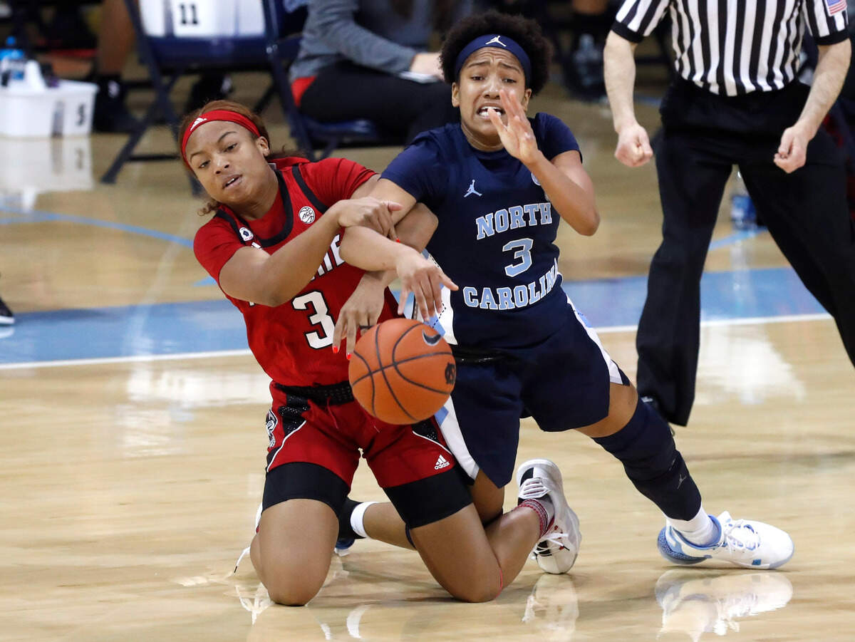 N.C. State’s Kai Crutchfield (3) and North Carolina’s Kennedy Todd-Williams (3) go after the ball during the first half of N.C. State’s game against UNC at Carmichael Arena in Chapel Hill, N.C., Sunday, February 7, 2021.