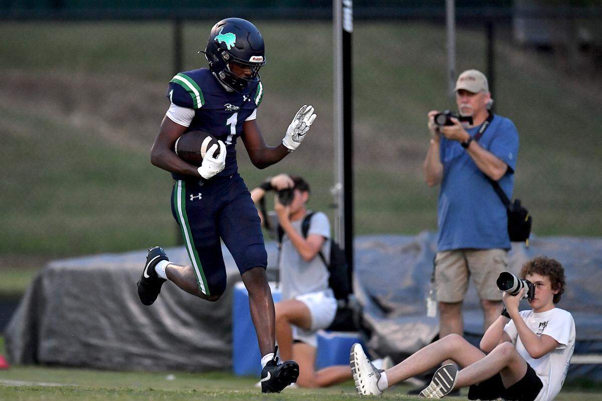 Leesville Road's Devin Goldston (1) waves to photographers after running for the long touchdown against Heritage during the first half. The Leesville Road Pride and the Heritage Huskies met in a football game in Raleigh, N.C. on September 5, 2025.