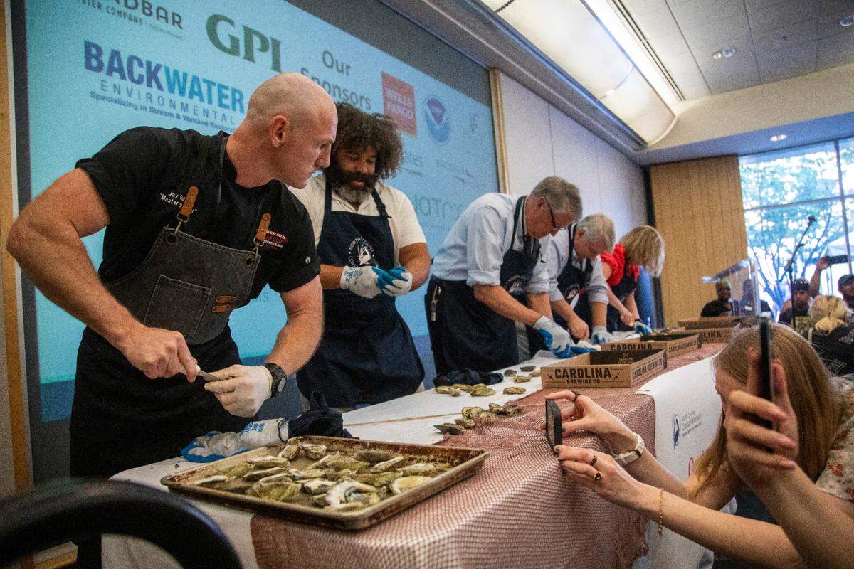 Jay Gallet, the nation’s fastest oyster-shucker, left, competes during NC Oyster Summit, Tuesday, May 9, 2023 at Marbles Kids Museum in Raleigh.