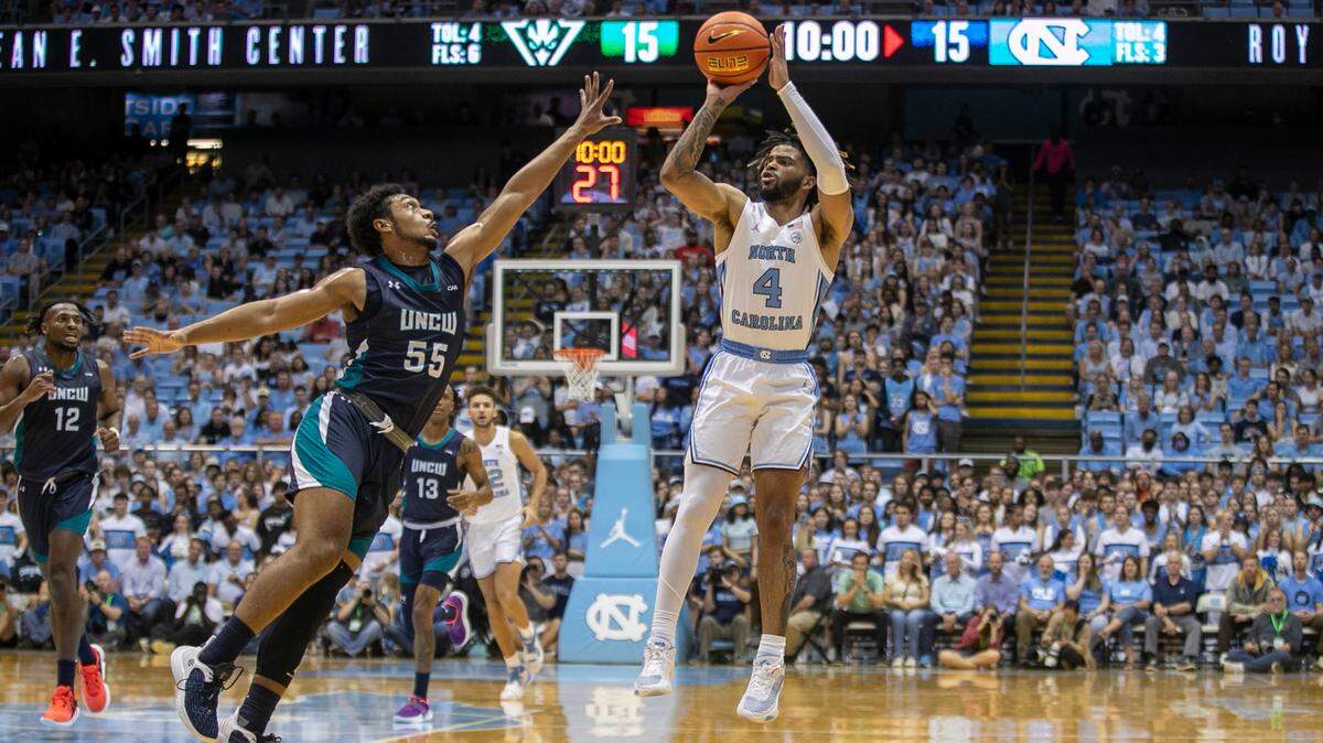 North Carolina’s R.J. Davis (4) launches a three-point shot during the first half against UNC-Wilmington’s Donovan Newby (55) on Monday, November 7, 2022 at the Smith Center in Chapel Hill, N.C.