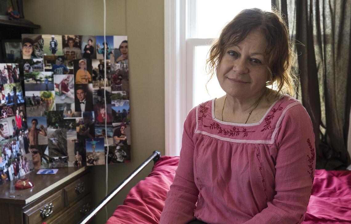 Susan Plattner poses for a portrait in her son Caleb Mehlman's room on March 16, 2018. Caleb passed away on his 19th birthday, December 19, 2017. His girlfriend made collages of photos of him with family and friends for his funeral.