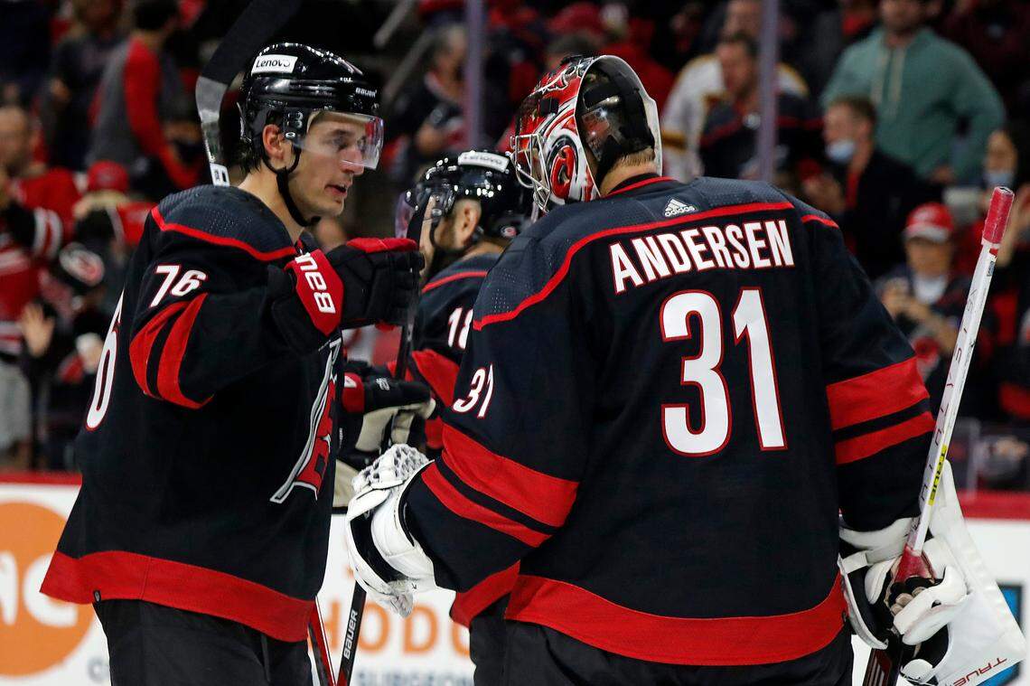 Carolina Hurricanes’ Brady Skjei (76) congratulates goaltender Frederik Andersen (31) on his win over the Arizona Coyotes at an NHL hockey game in Raleigh, N.C., Sunday, Oct. 31, 2021. (AP Photo/Karl B DeBlaker)