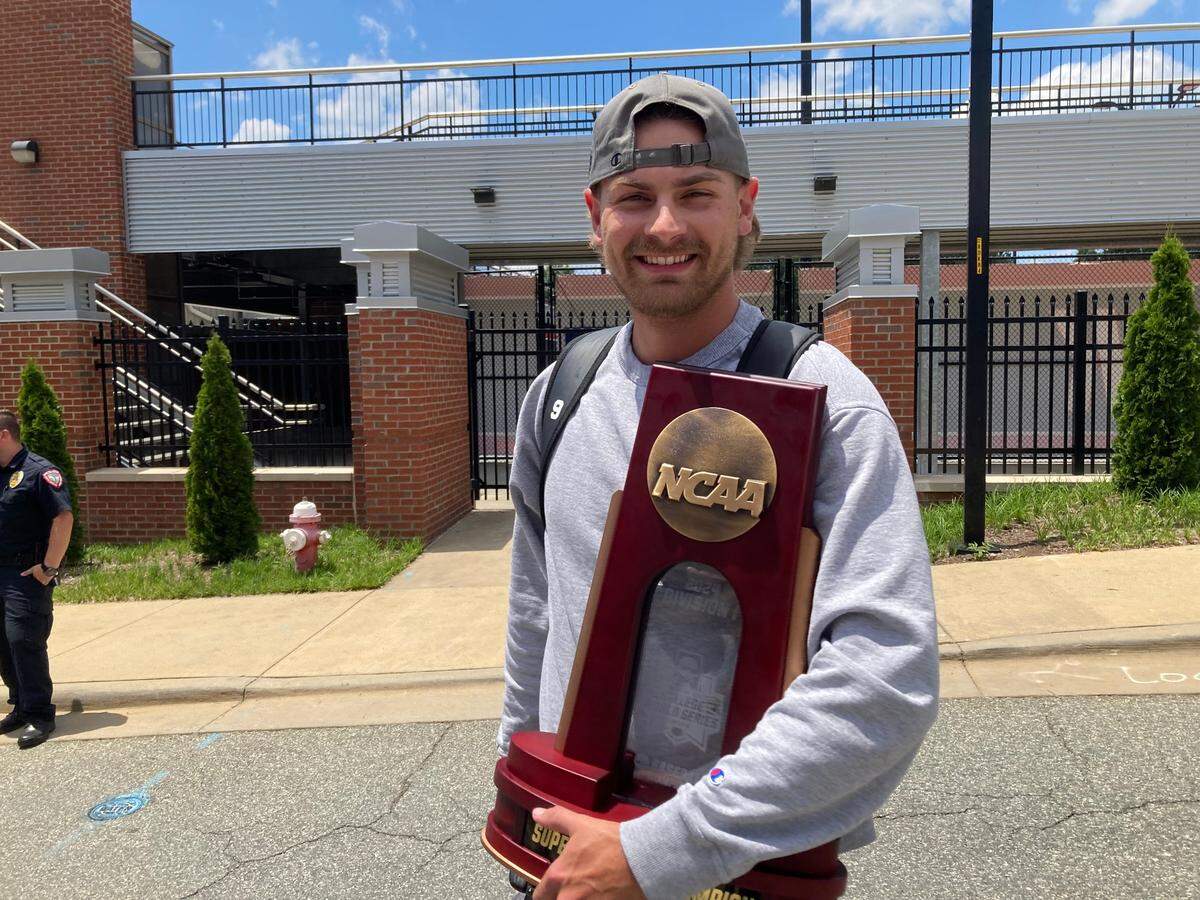 NC State pitcher Logan Whitaker shows off the trophy from winning the NCAA Athens Regional against Georgia after the baseball team’s return June 11, 2024.