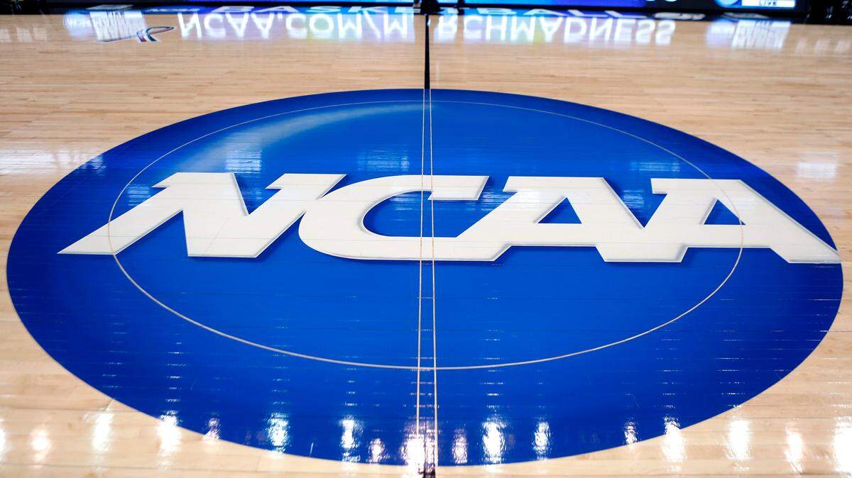 In this March 18, 2015, file photo, the NCAA logo is displayed at center court as work continues at The Consol Energy Center in Pittsburgh, for the NCAA college basketball tournament.