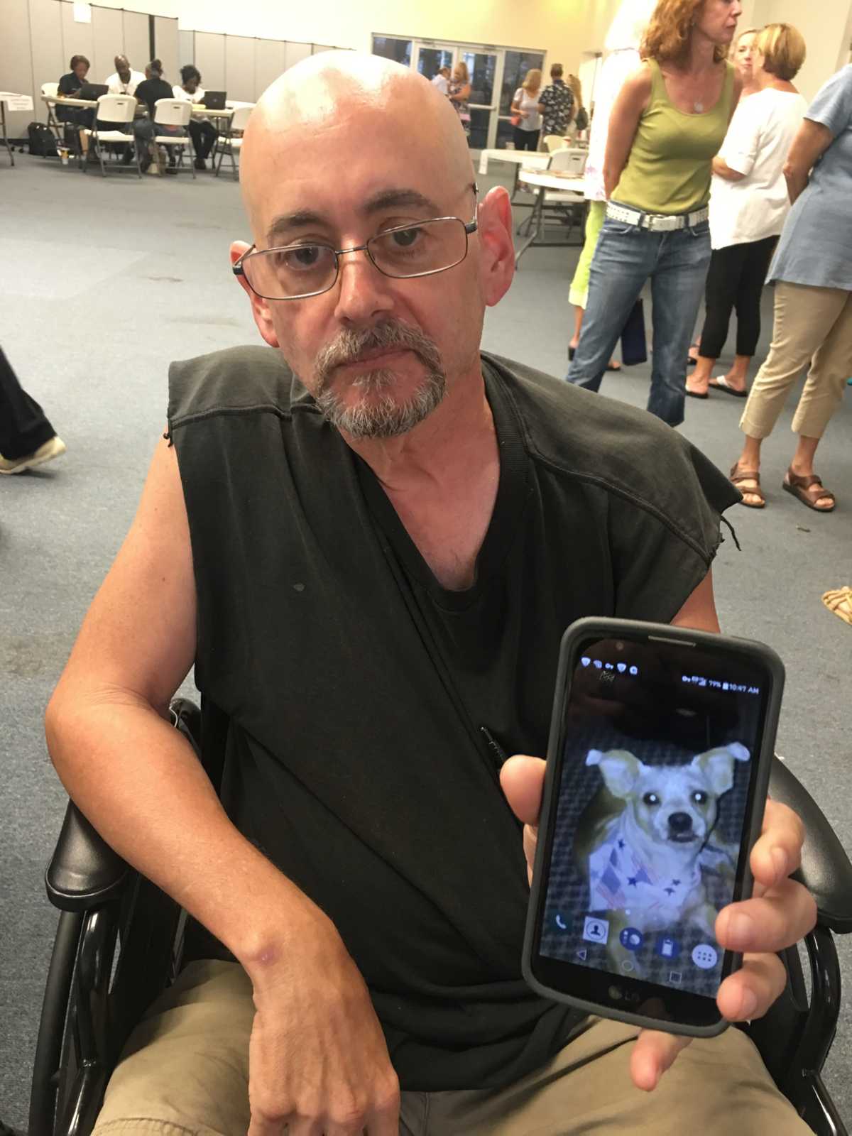 Alex Carias, 60, shows a picture of his terrier, Gus, who joined him and rode out Hurricane Florence inside their pickup truck in Carteret County. The two have stayed at a Red Cross shelter in Morehead City.