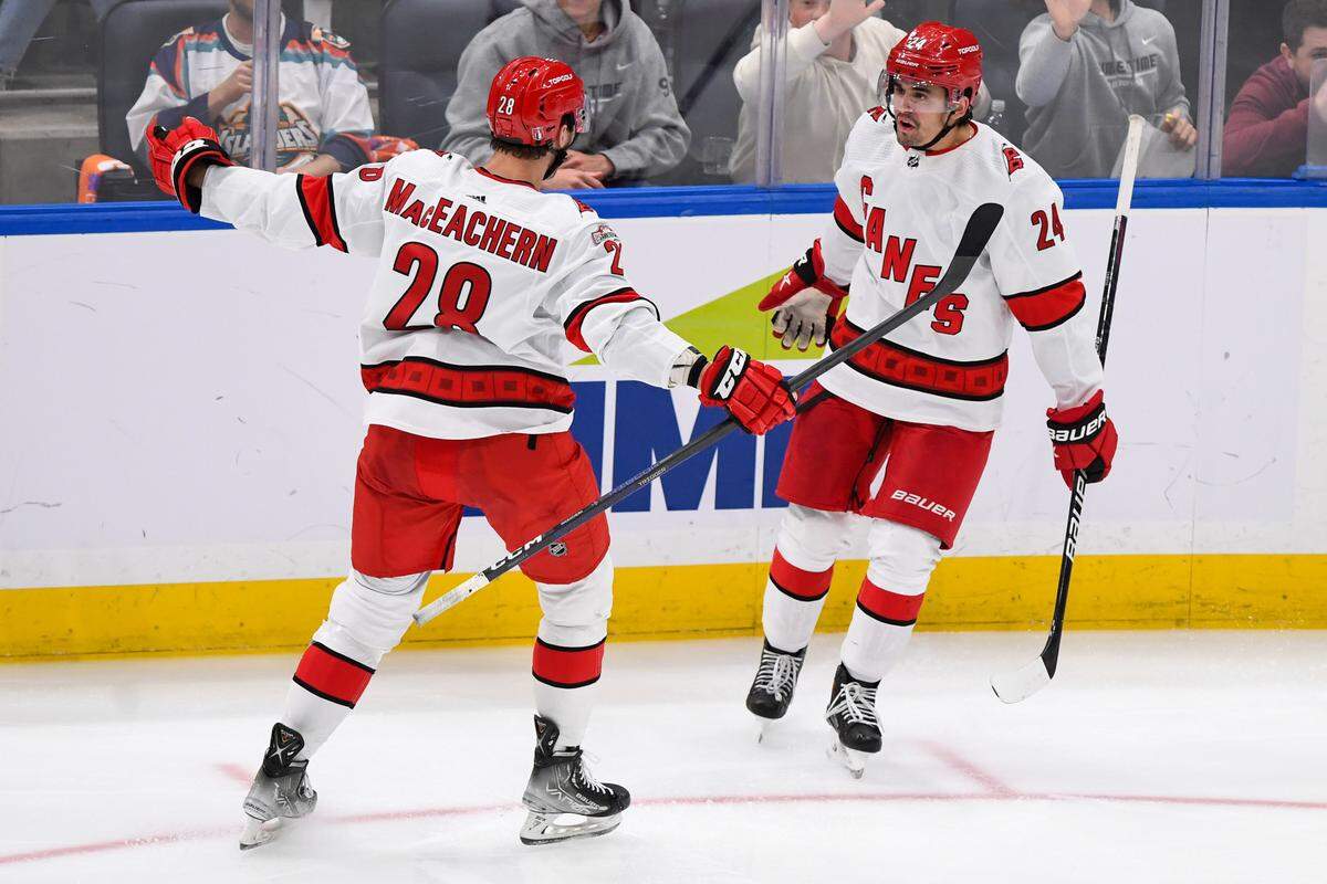 Carolina Hurricanes center Seth Jarvis (24) celebrates his goal against the New York Islanders with Carolina Hurricanes left wing Mackenzie MacEachern (28) during the third period in game four of the first round of the 2023 Stanley Cup Playoffs at UBS Arena.