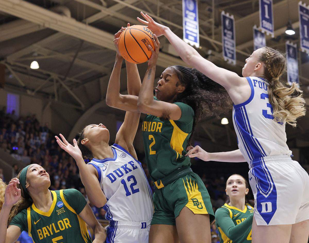 Baylor’s Kiersten Johnson grabs a rebound away from Duke’s Delaney Thomas and Toby Fournier during the first half of the Blue Devils’ 69-46 second-round NCAA Tournament win on Sunday, March 22, 2026, at Cameron Indoor Stadium in Durham, N.C.