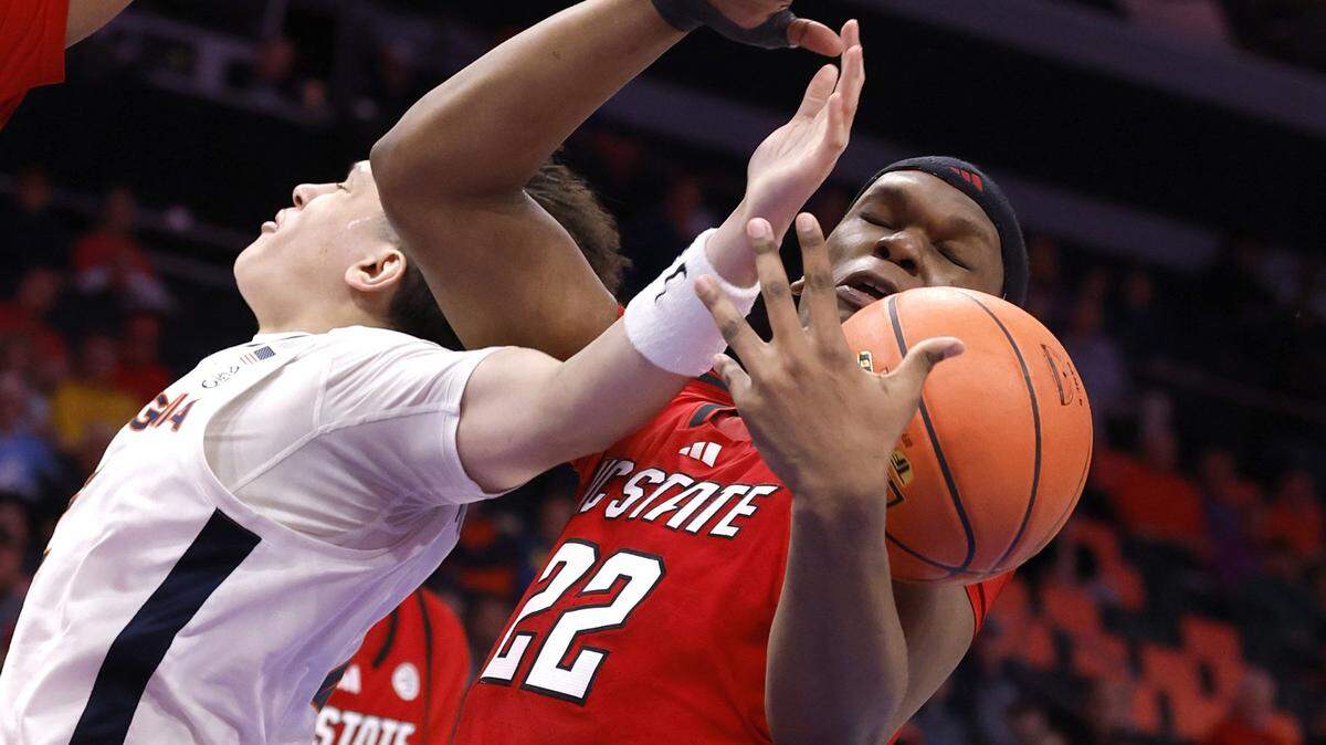 N.C. State's Ven-Allen Lubin (22) pulls the rebound from Virginia's Chance Mallory (2) during the first half of N.C. State’s game against Virginia in the quarterfinals of the 2026 ACC Men’s Basketball Tournament at the Spectrum Center in Charlotte, N.C., Thursday, March 12, 2026.