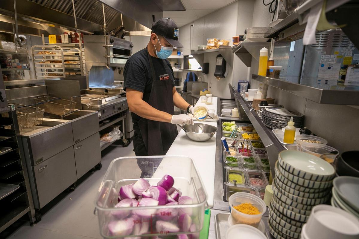 Samuel Hernandez prepares a lunch order in the kitchen at Locals Oyster Bar in the Transfer Co. Food Hall on Tuesday, October 26, 2021 in Raleigh, N.C. Hernandez has worked at Locals for three years.