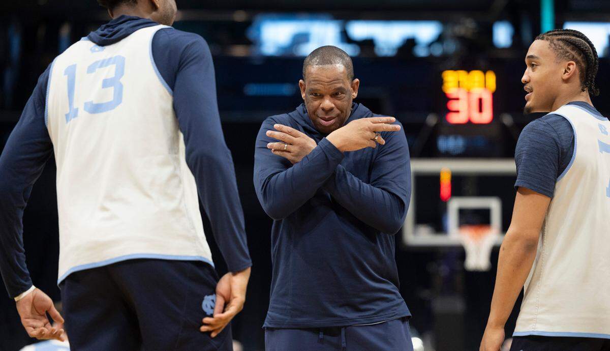 North Carolina coach Hubert Davis jokes around with Jalen Washington (13) and Seth Trimble (7) during their practice on Wednesday, March 20, 2024 as they prepare for the NCAA Tournament at Spectrum Center in Charlotte, N.C.