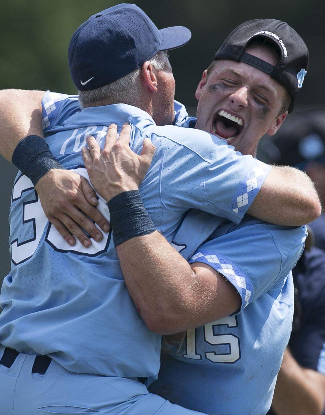 North Carolina coach Mike Fox embraces first baseman Michael Busch (15) after the Tar Heels secured their trip to the College World Series, defeating Stetson 7-5 clinching the NCAA Super Regional on Saturday, June 9, 2018 at Boshamer Stadium in Chapel Hill, N.C.