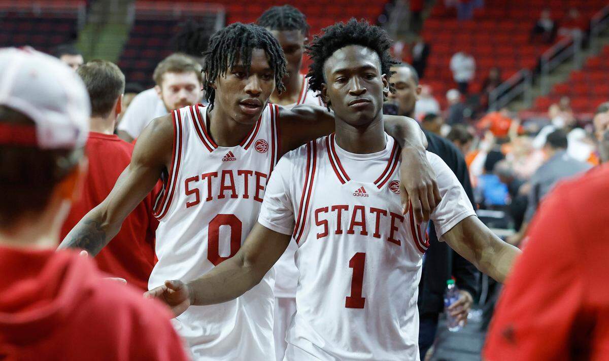N.C. State’s Terquavion Smith (0) and Jarkel Joiner (1) walk off the court after Clemson’s 96-71 victory over N.C. State’s game at PNC Arena in Raleigh, N.C., Saturday, Feb. 25, 2023.