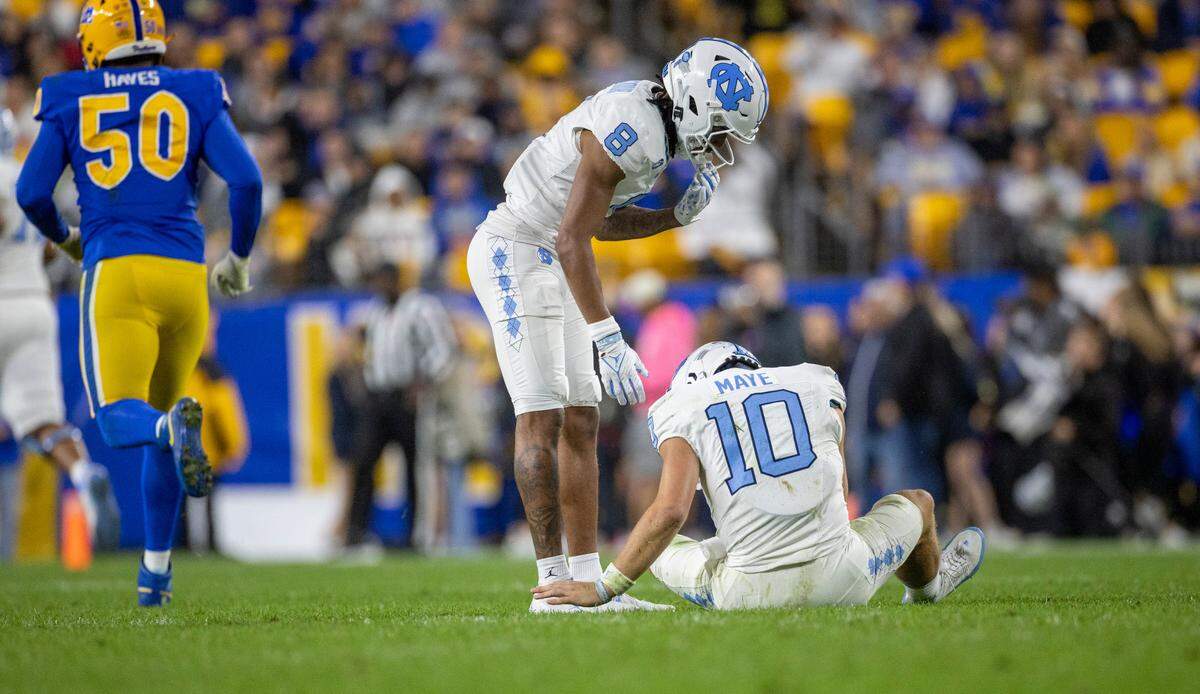 North Carolina’s Kobe Paysour (8) checks on quarterback Drake Maye (10)after taking a hard hit on a roughing the passer penalty by Pitt’s Damon Hayes (50) in the second quarter on Saturday, September 23, 2023 at Acrisure Stadium in Pittsburgh, Pa. Maye missed the next play but did return to finish the quarter.