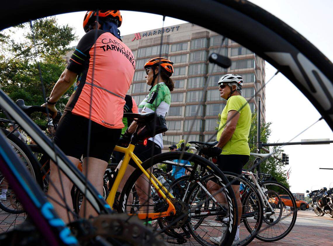 People listen to remarks prior to the Ride of Silence on Wednesday, May 17, 2023, in Durham, N.C. The event remembers those who were killed or injured while biking.