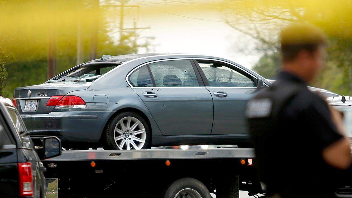 Multiple bullet holes are visible in a car that was damaged in a police involved shooting is removed from the scene, Wednesday, April 21, 2021, in Elizabeth City, N.C. A North Carolina deputy shot and killed a man while executing a search warrant Wednesday, the sheriff’s office said. (Stephen M. Katz/The Virginian-Pilot via AP)