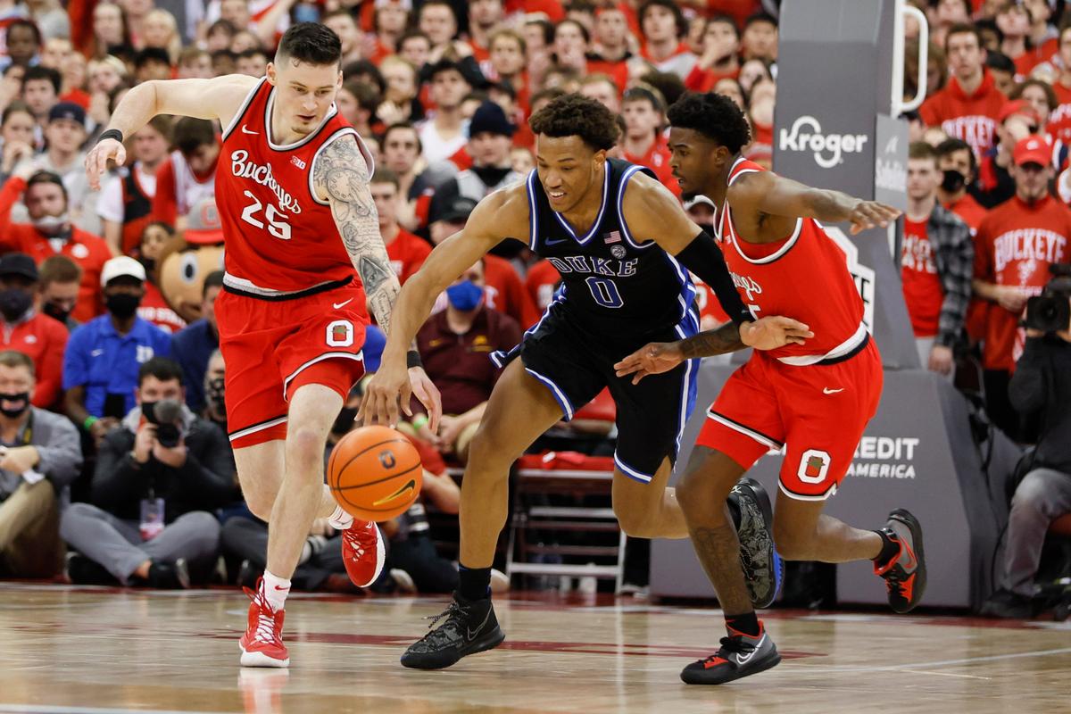 Ohio State’s Kyle Young, left, and Jamari Wheeler, right, and Duke’s Wendell Moore chase a loose ball during the first half of an NCAA college basketball game Tuesday, Nov. 30, 2021, in Columbus, Ohio.