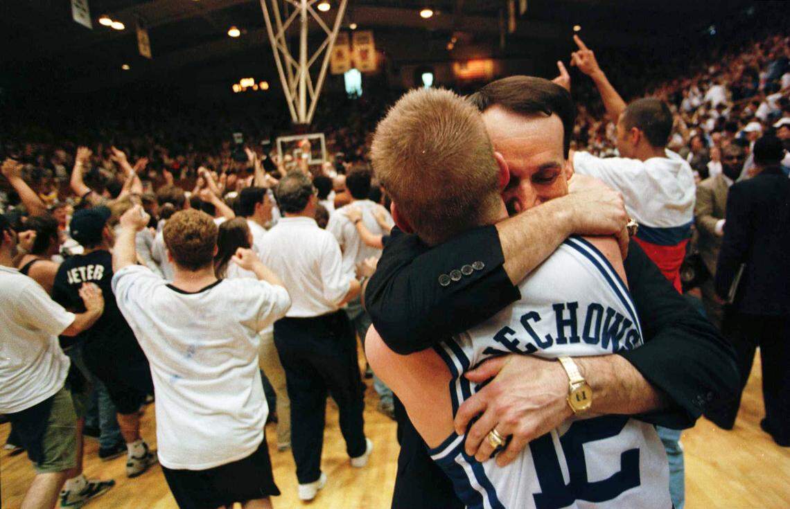 Duke coach Mike Krzyzewski celebrates with senior guard Steve Wojciechowski, who had 11 assists, three steals, and one turnover in the Blue Devils’ comeback against North Carolina in 1998.