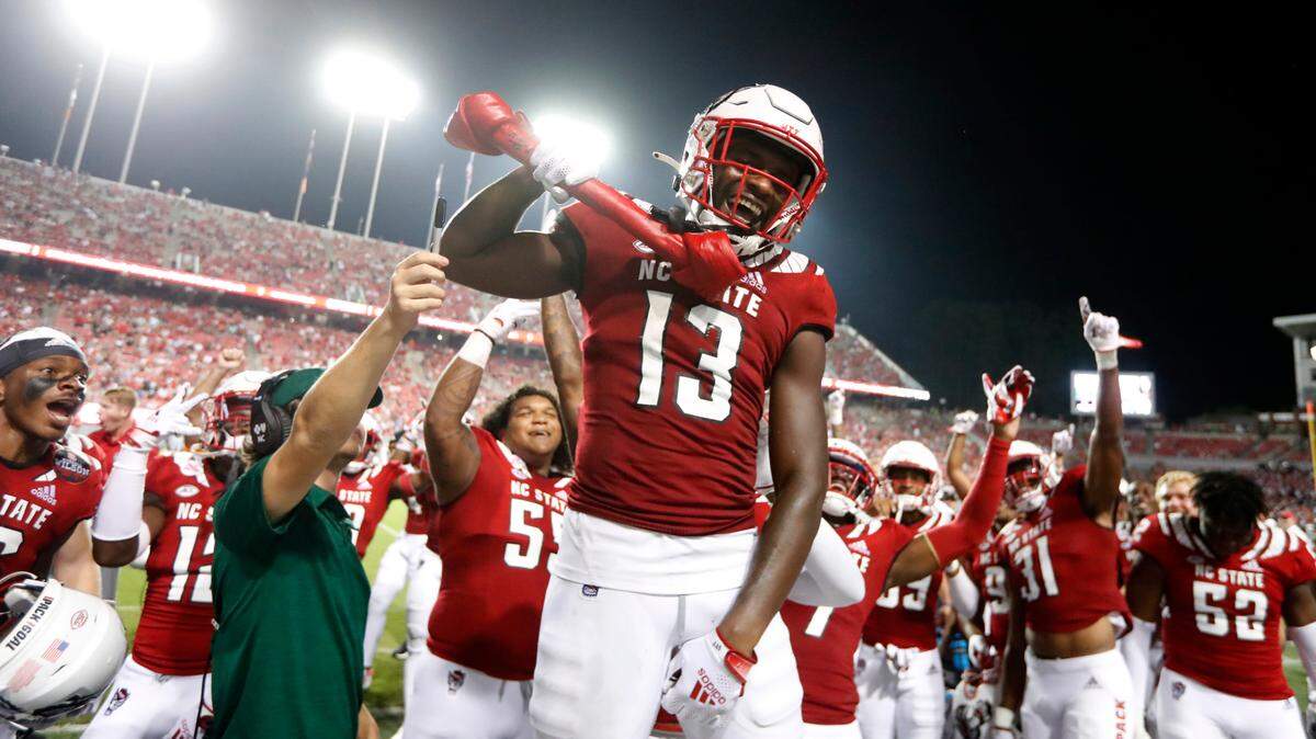 N.C. State defensive back Tyler Baker-Williams (13) celebrates making an interception with the turnover bone during the second half of N.C. State’s 45-7 victory over Furman at Carter-Finley Stadium in Raleigh, N.C., Saturday, Sept 18, 2021.